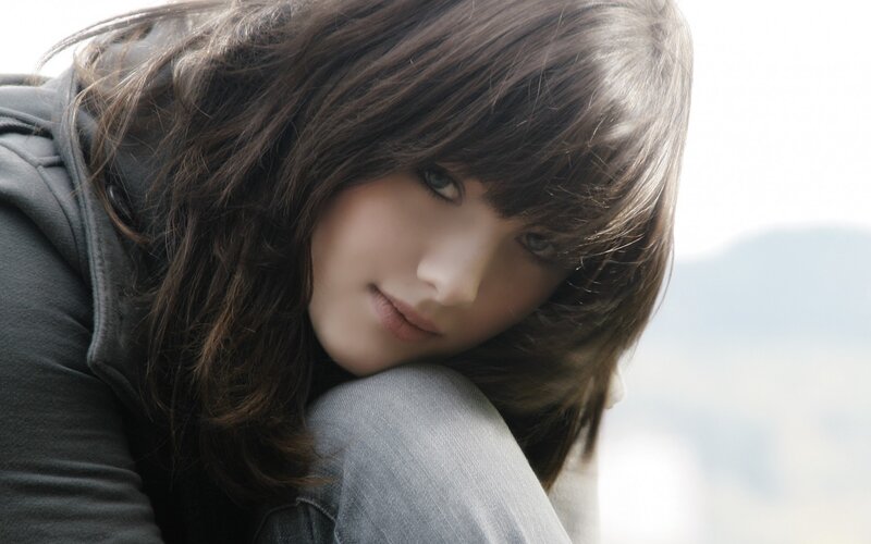 woman with brown hair looking down