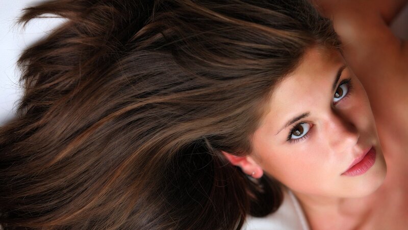 woman with brown hair lying down