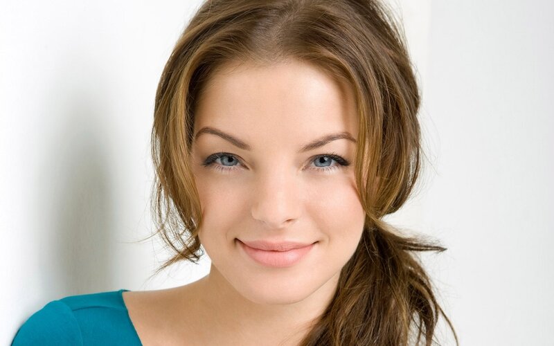 Woman with Brown Hair — Neutral, Photograph, Blue Eyes, Teal Shirt, White Wall