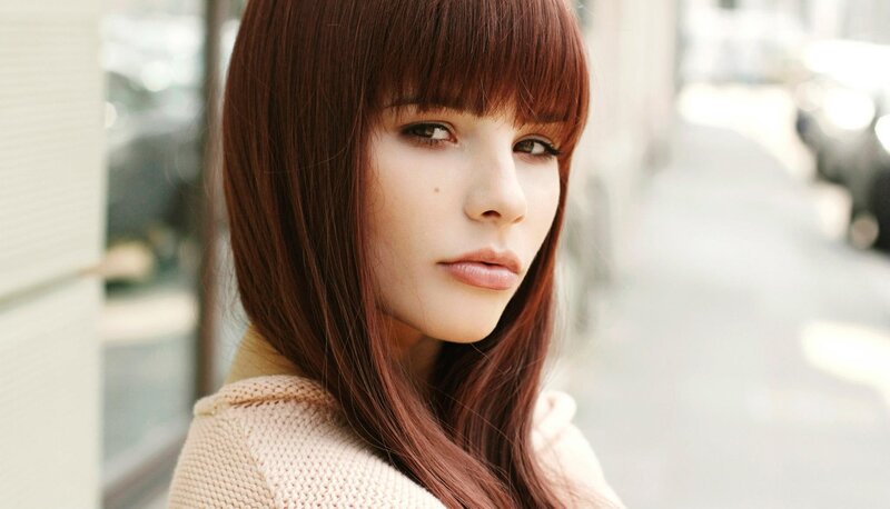 woman with brown hair on street