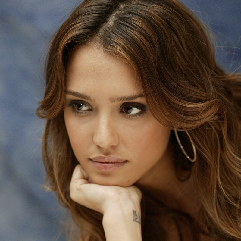woman with brown hair resting hand