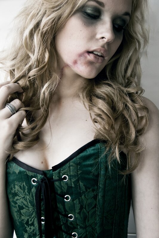 woman with bruises and dark makeup