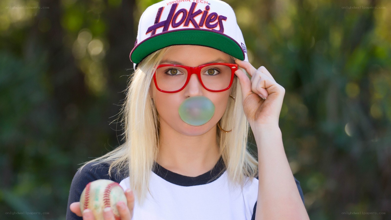 Woman with bubble gum and baseball