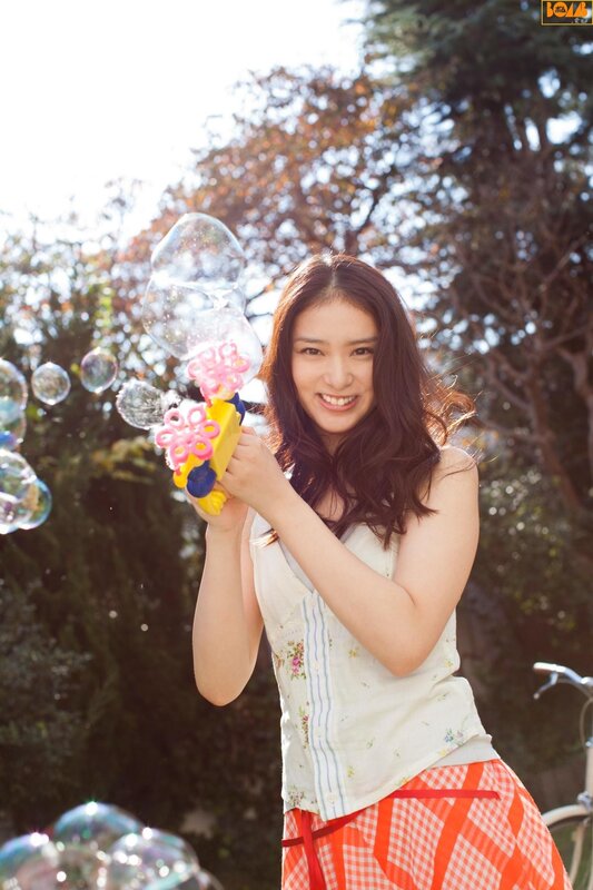 Woman with bubble gun outdoors