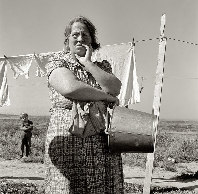 Woman with bucket in field