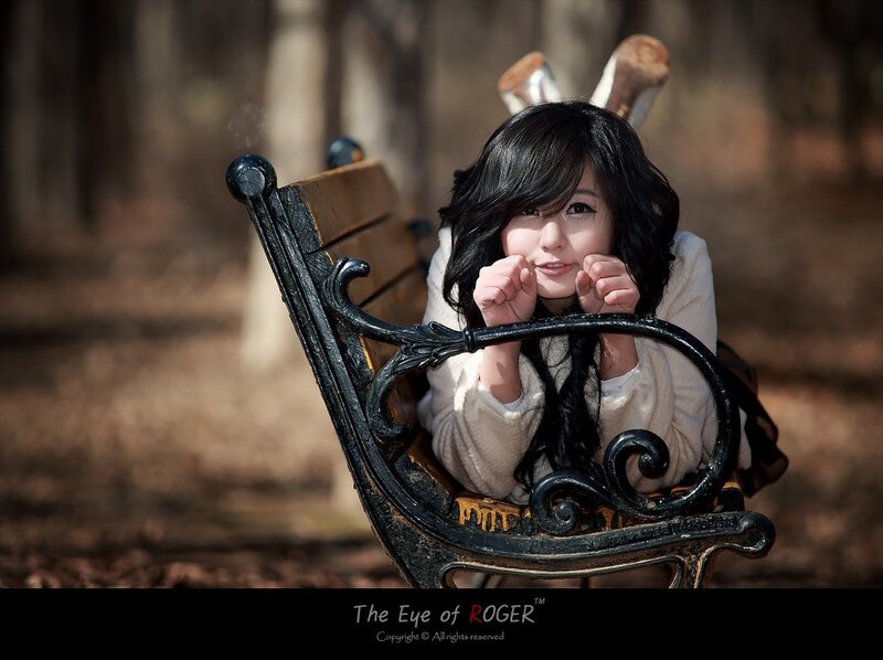 woman with bunny ears on bench