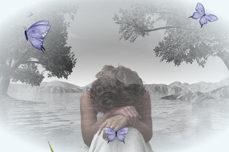 woman with butterflies by water