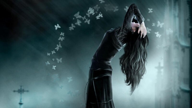 woman with butterflies in dark setting