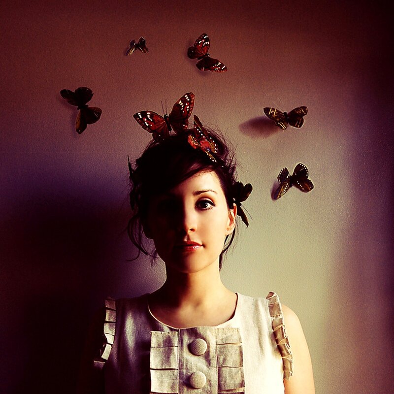woman with butterflies on her head