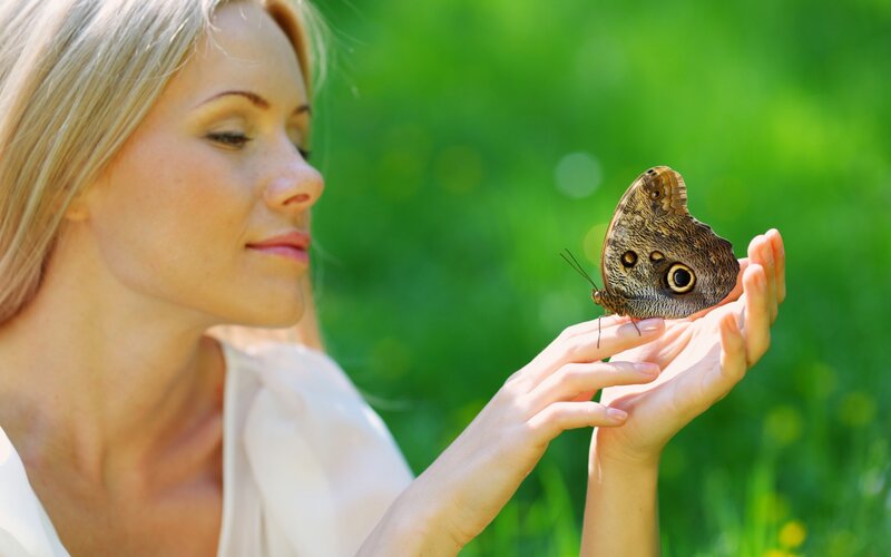 woman with butterfly on hand