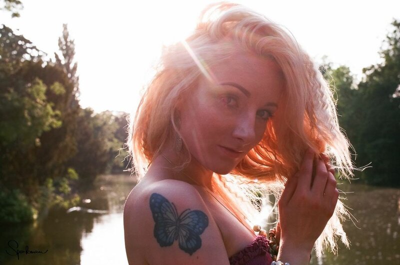 woman with butterfly tattoo at sunset