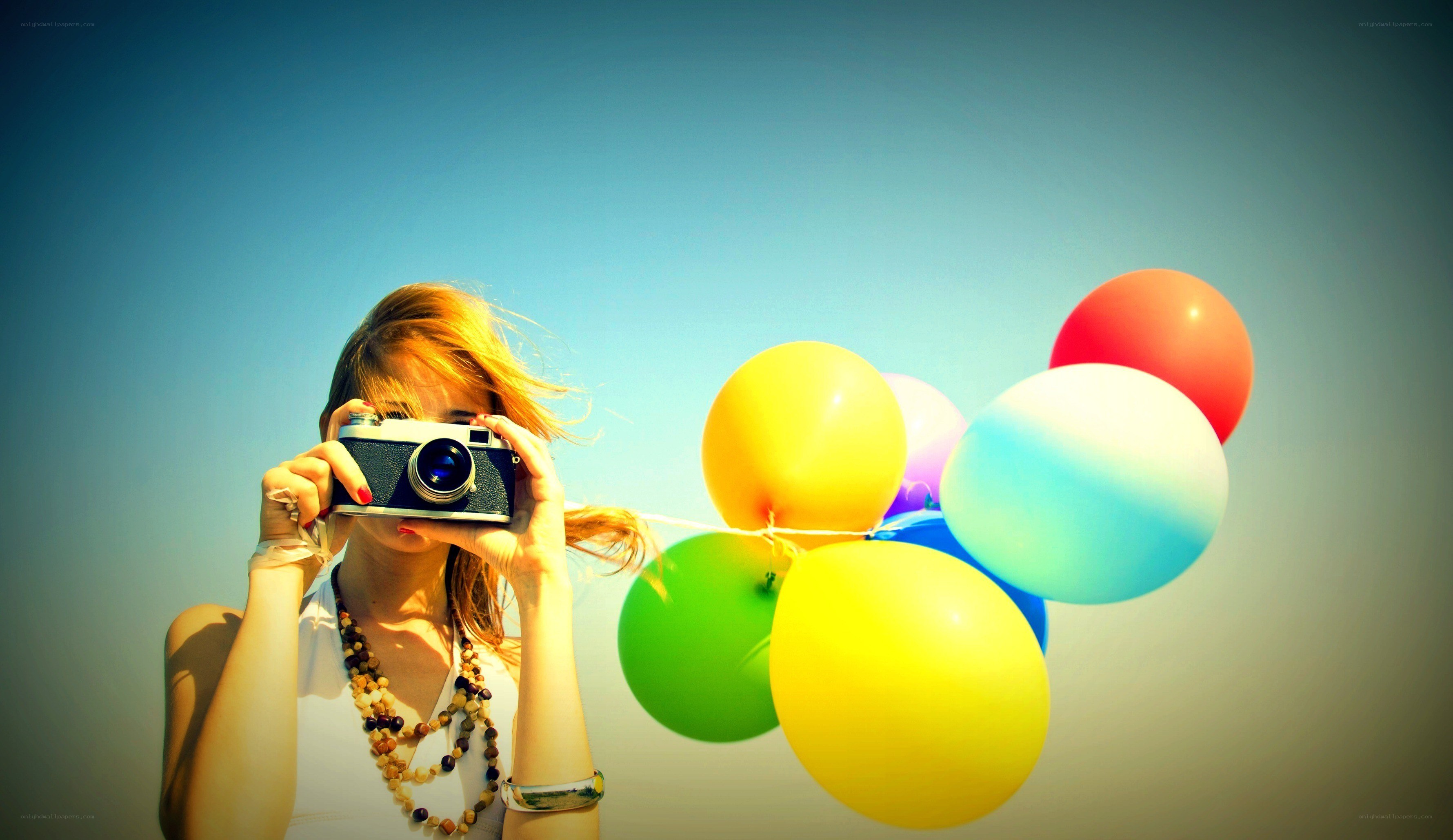 woman with camera and balloons