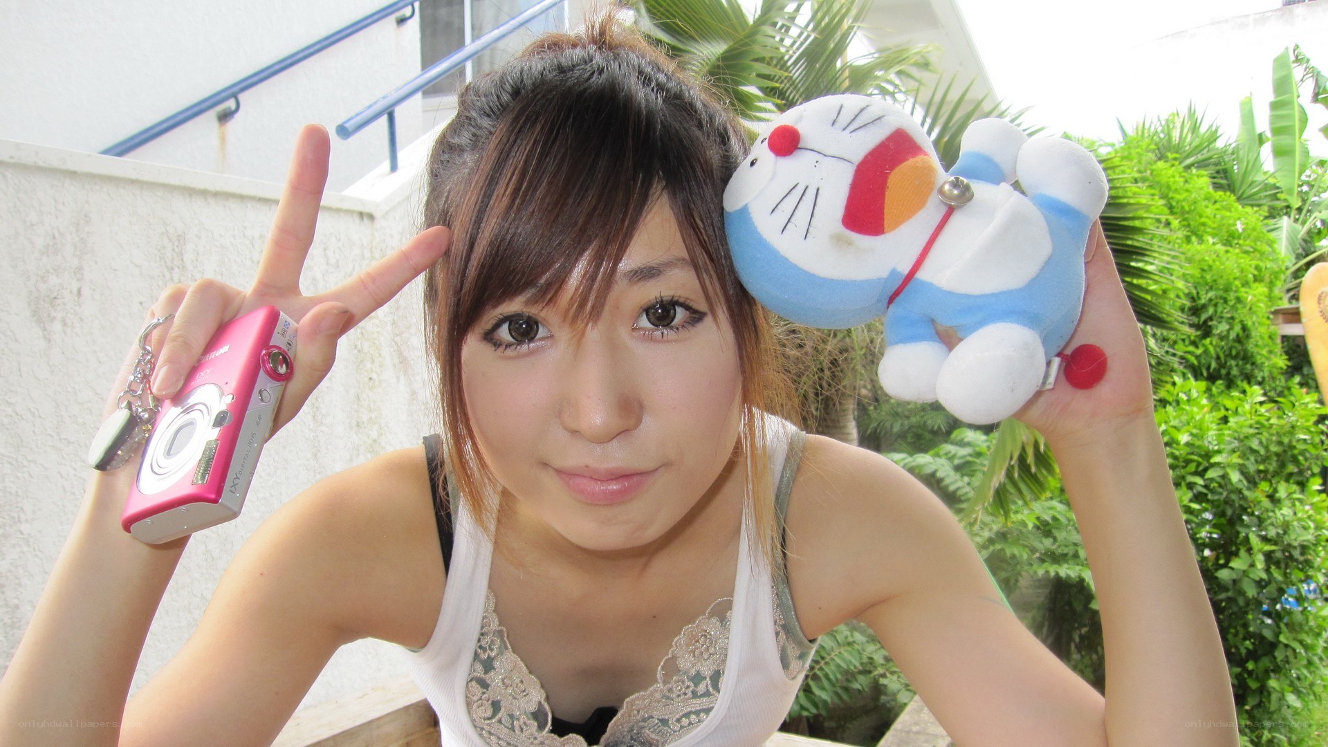 Woman with camera and Doraemon plush