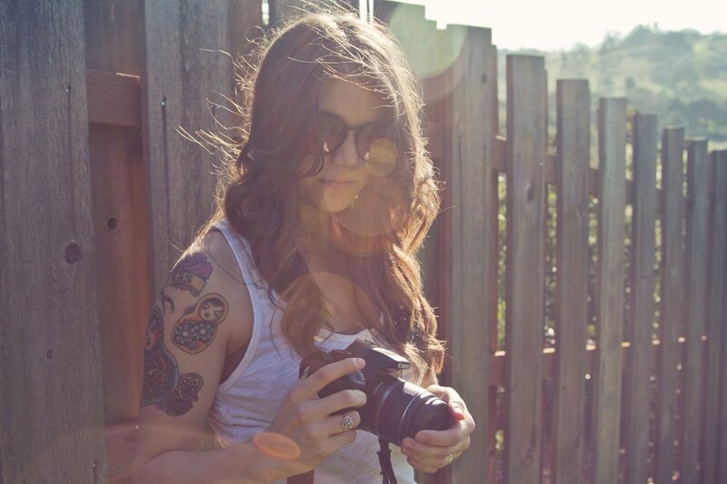 woman with camera and tattoos
