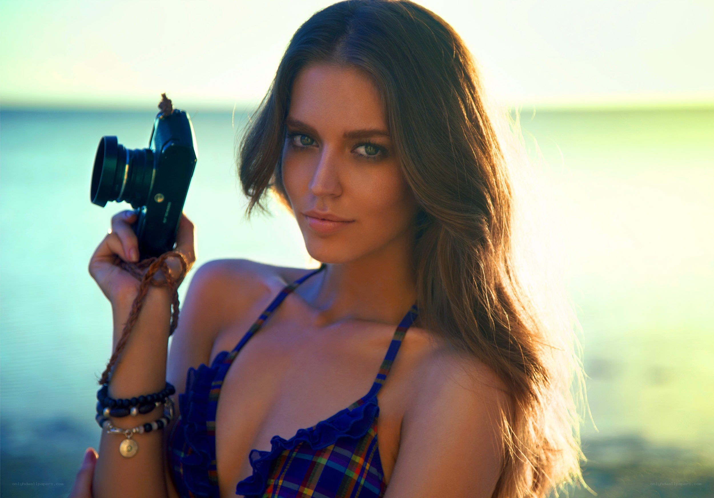 Woman with camera at beach