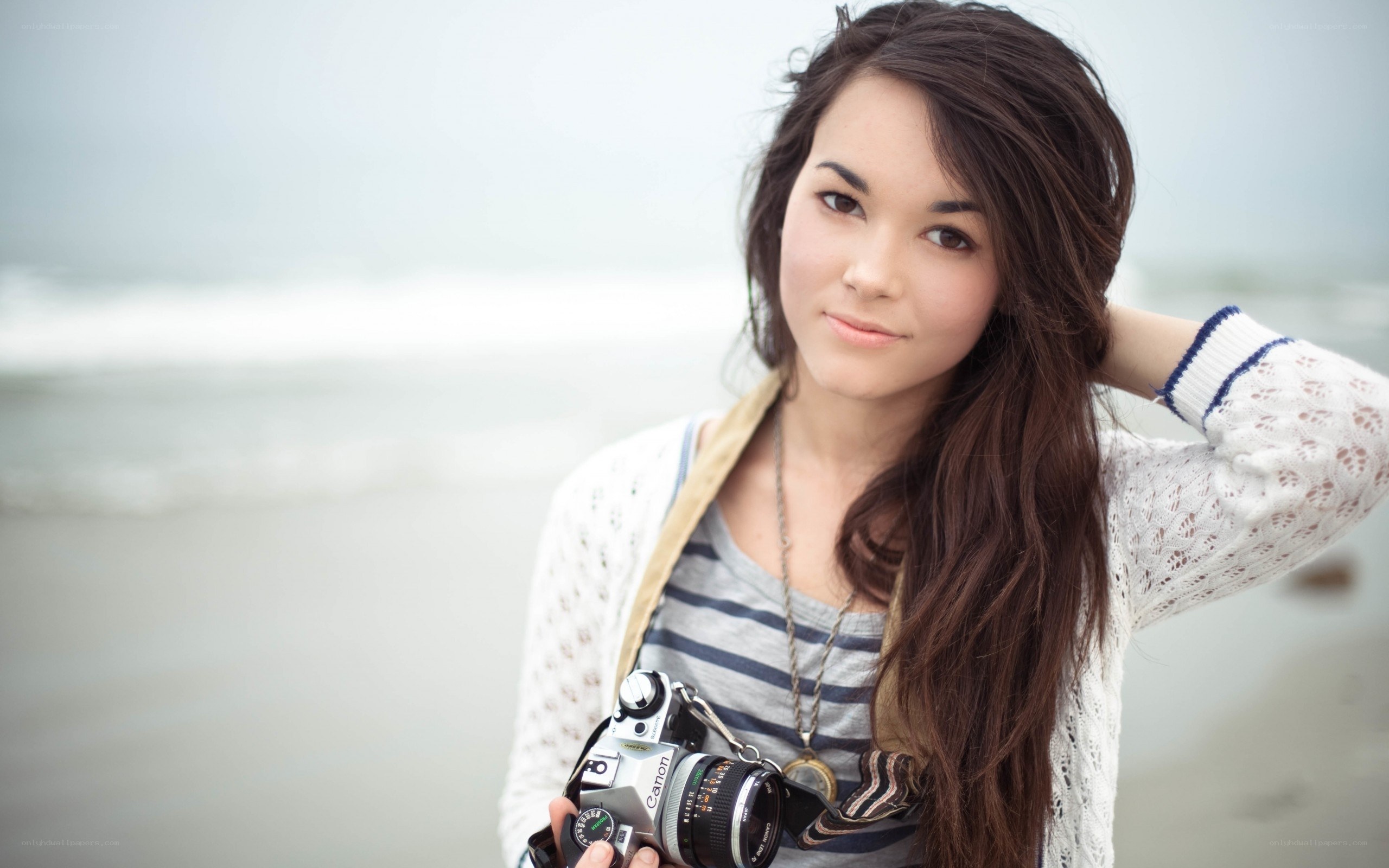 woman with camera at beach