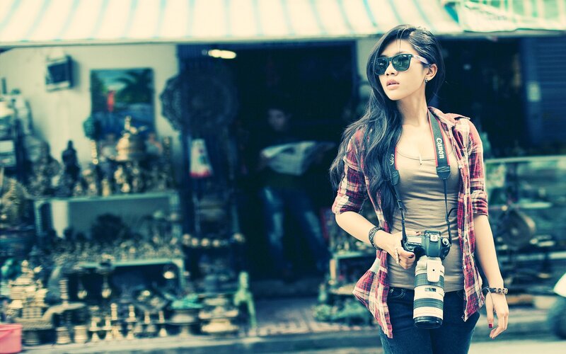 woman with camera at market