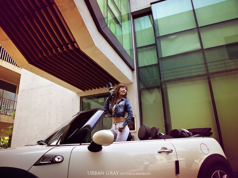 Woman with camera by convertible