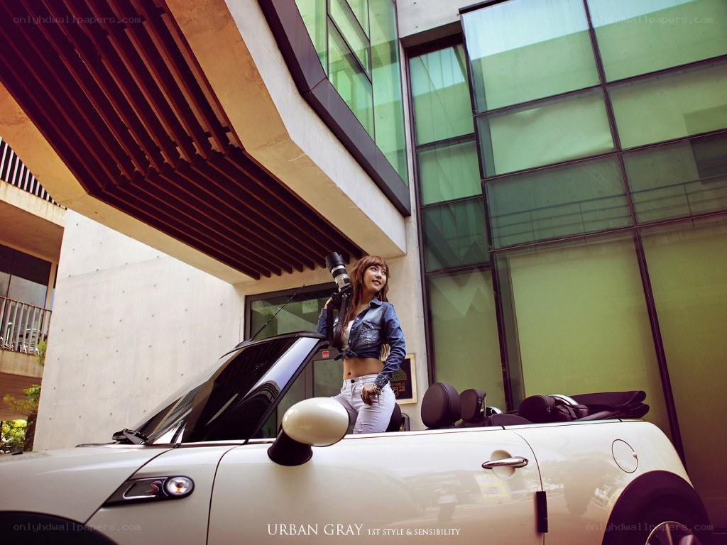 Woman with camera by convertible