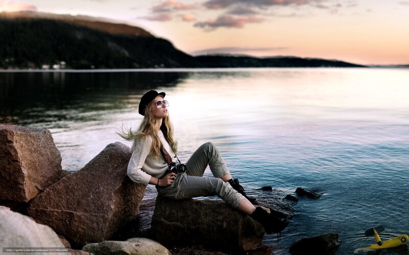 Woman with camera by the water