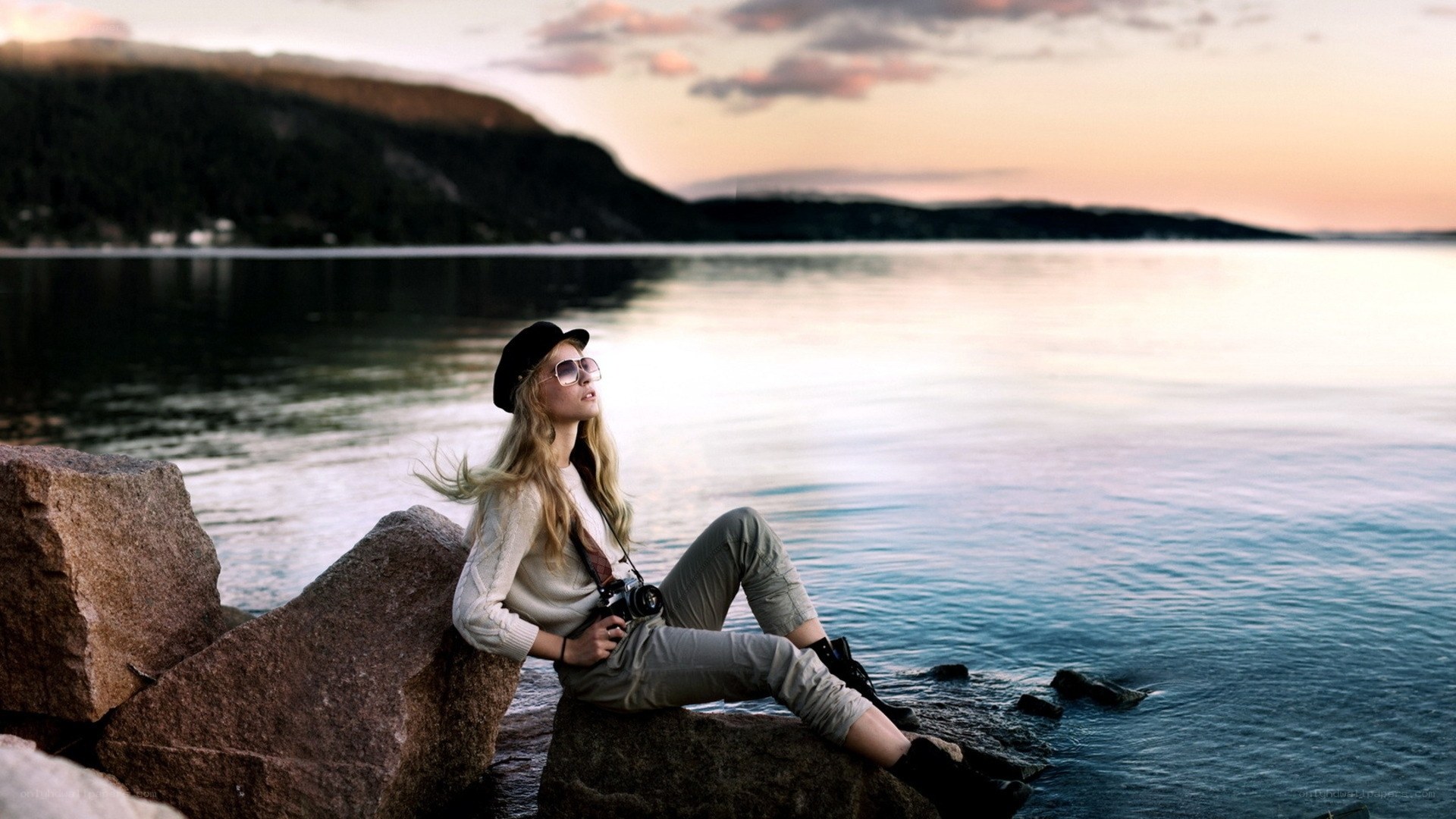 Woman with camera by the water