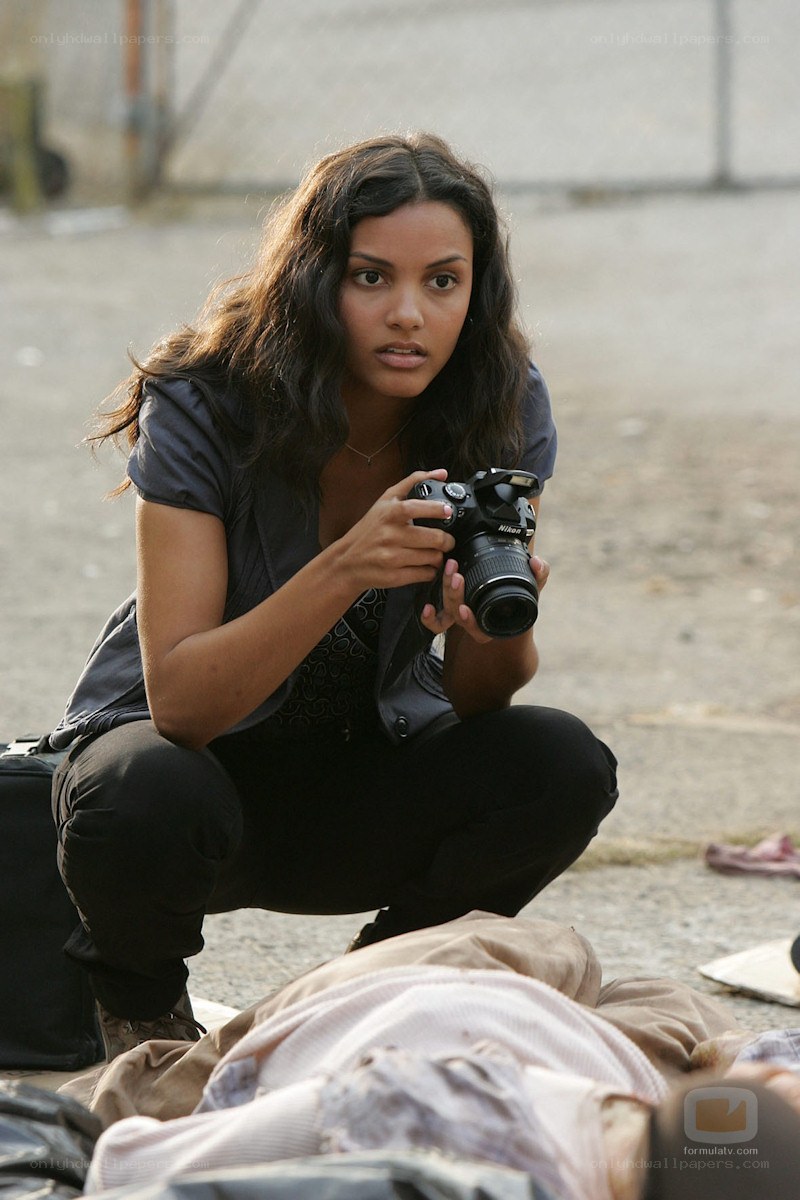 Woman with camera crouching