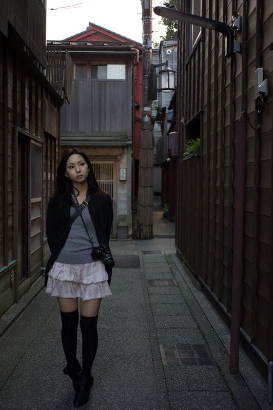Woman with camera in alley