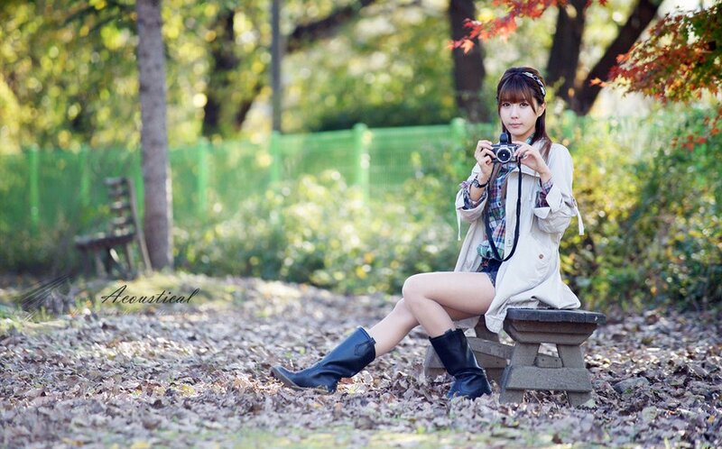 Woman with camera in autumn park