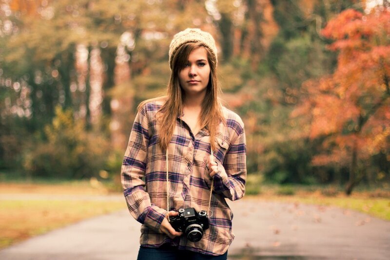 woman with camera in autumn