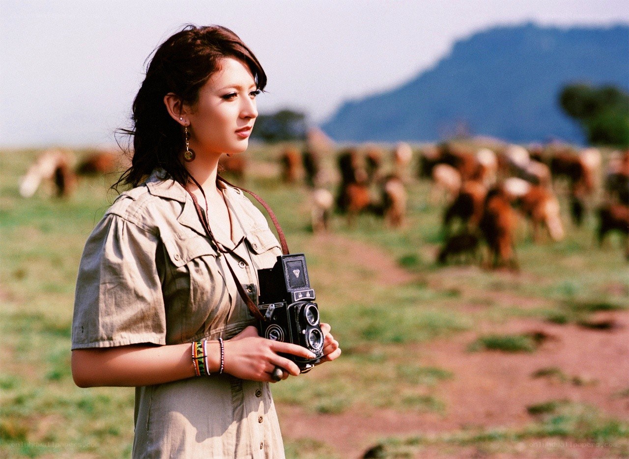Woman with camera in field
