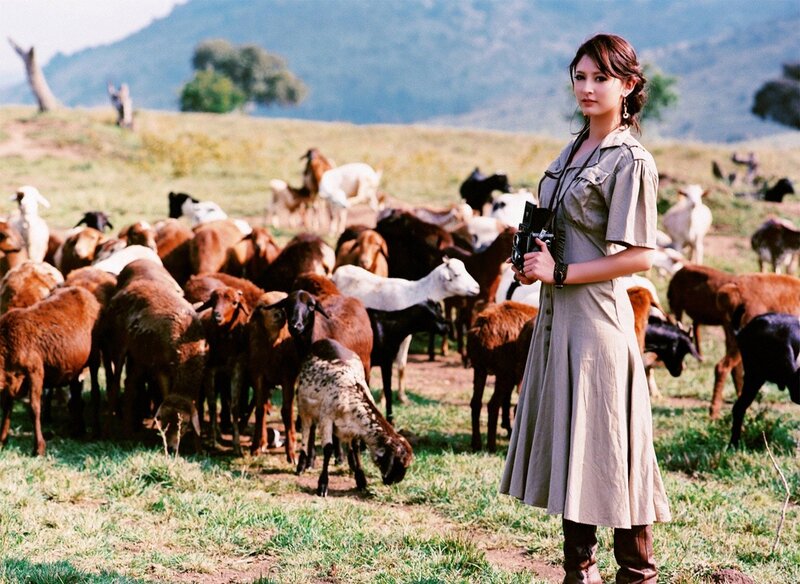 Woman with camera in field