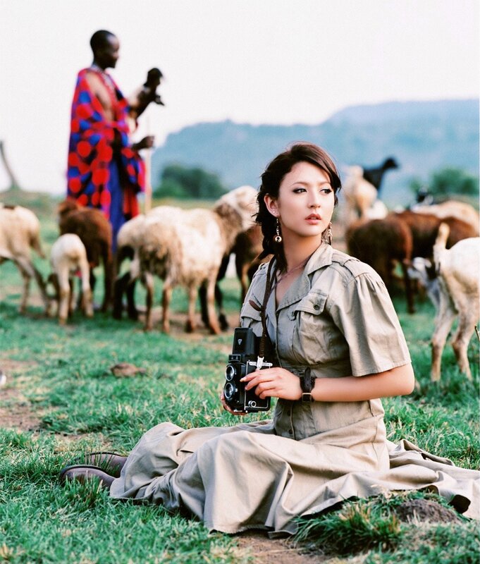 Woman with camera in field