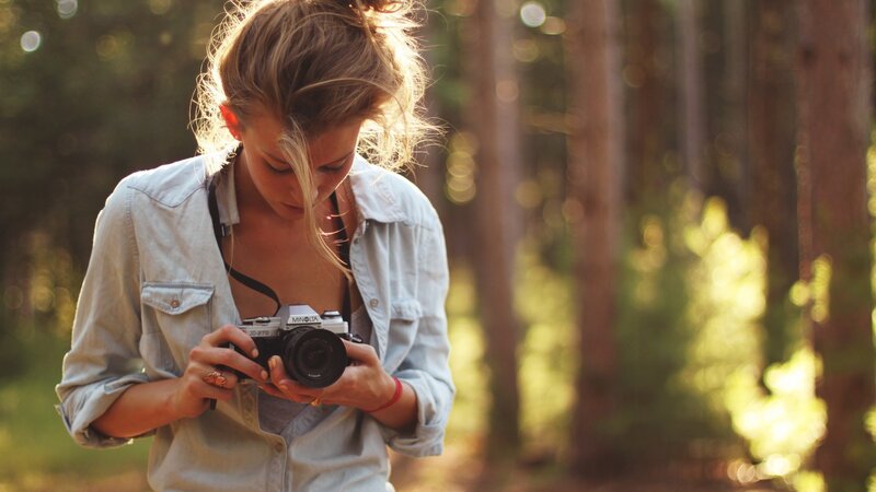 woman with camera in forest