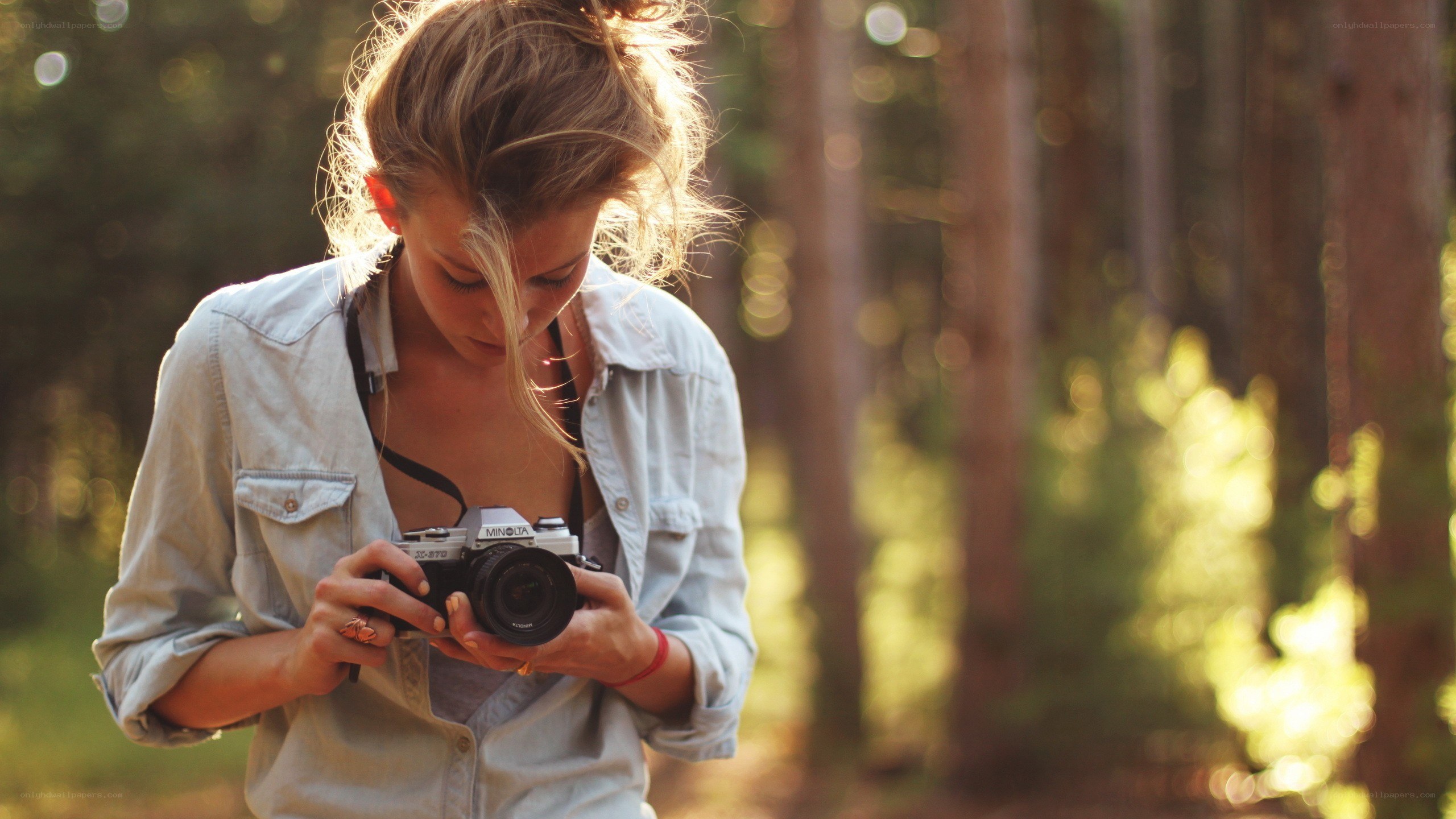 woman with camera in forest