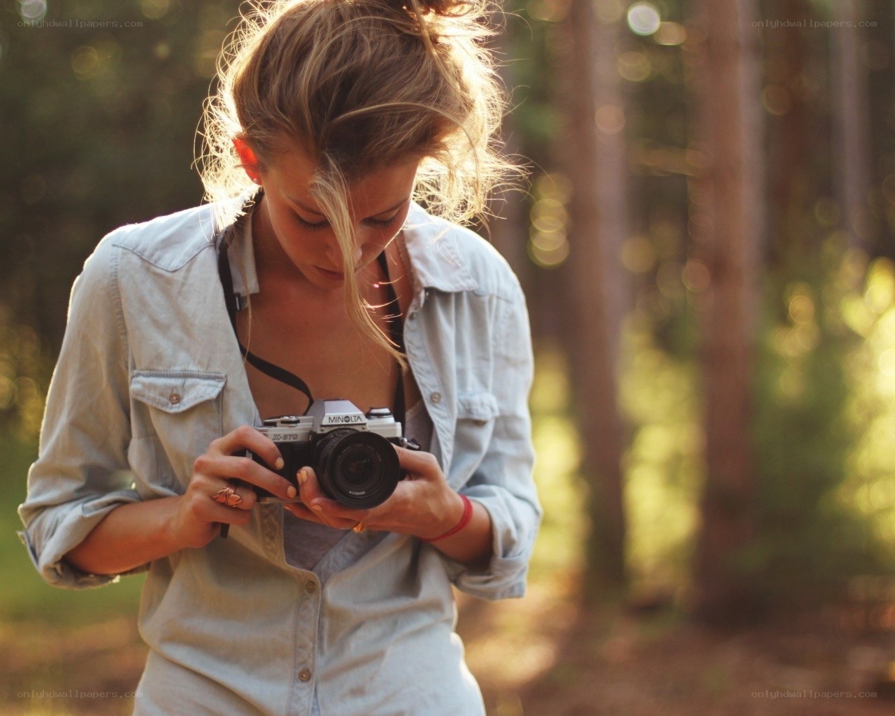woman with camera in forest
