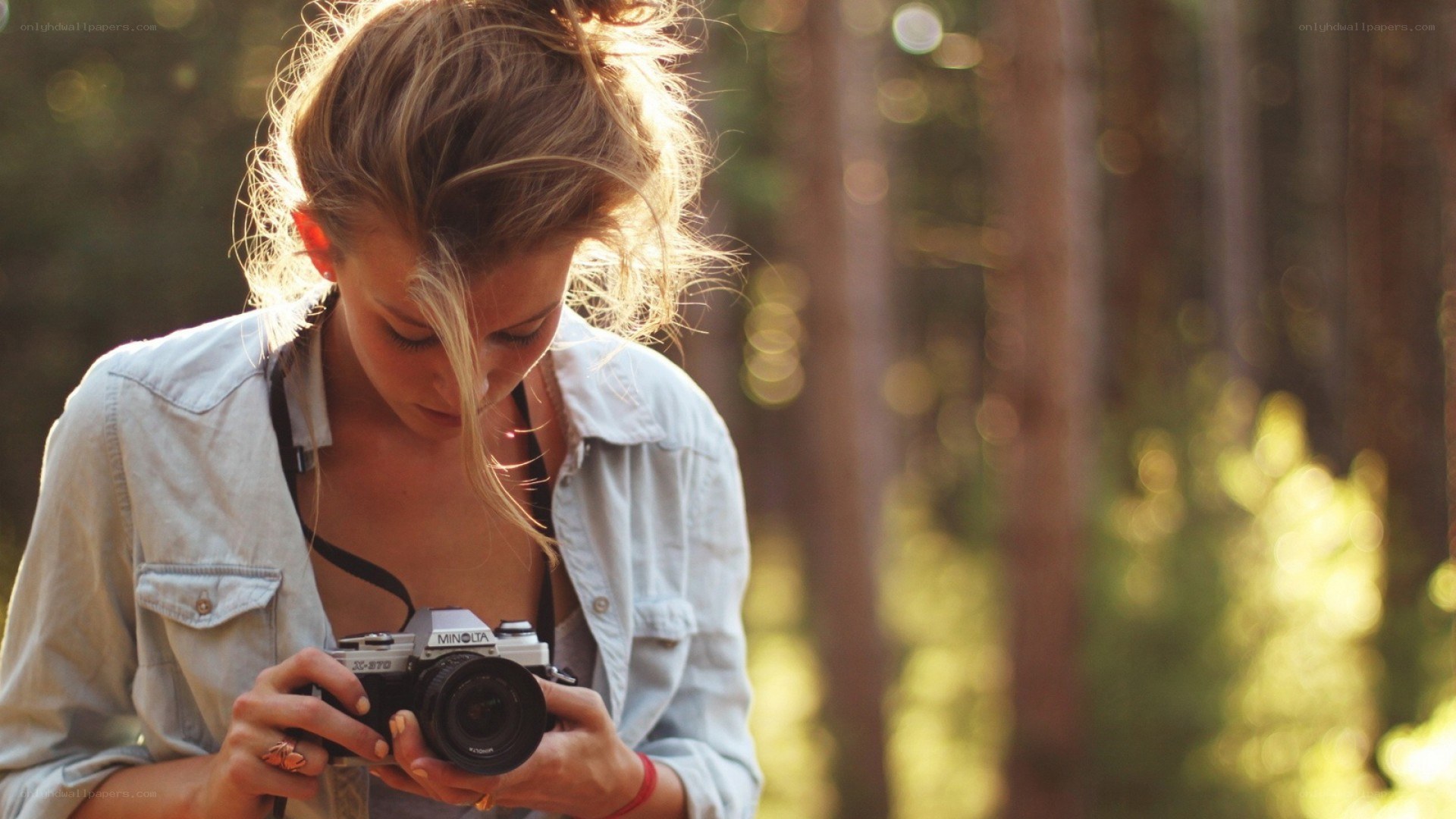 woman with camera in forest