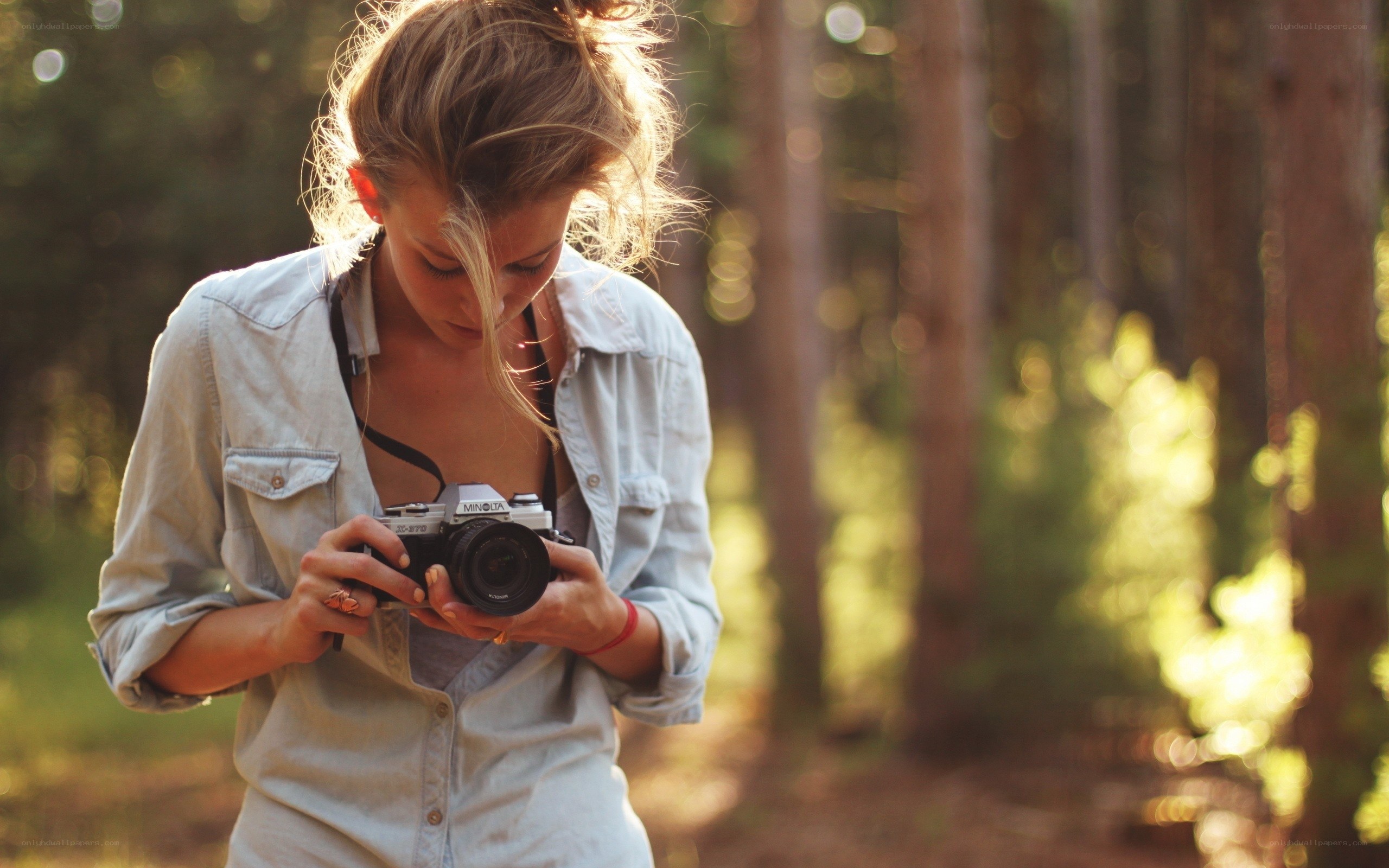 woman with camera in forest