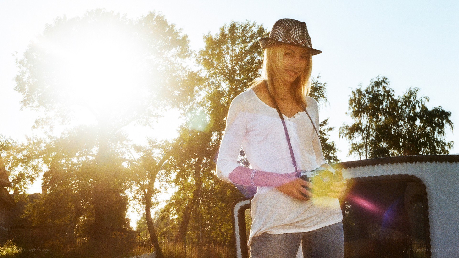woman with camera in sunlight