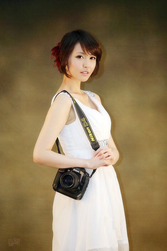 Woman with camera in white dress