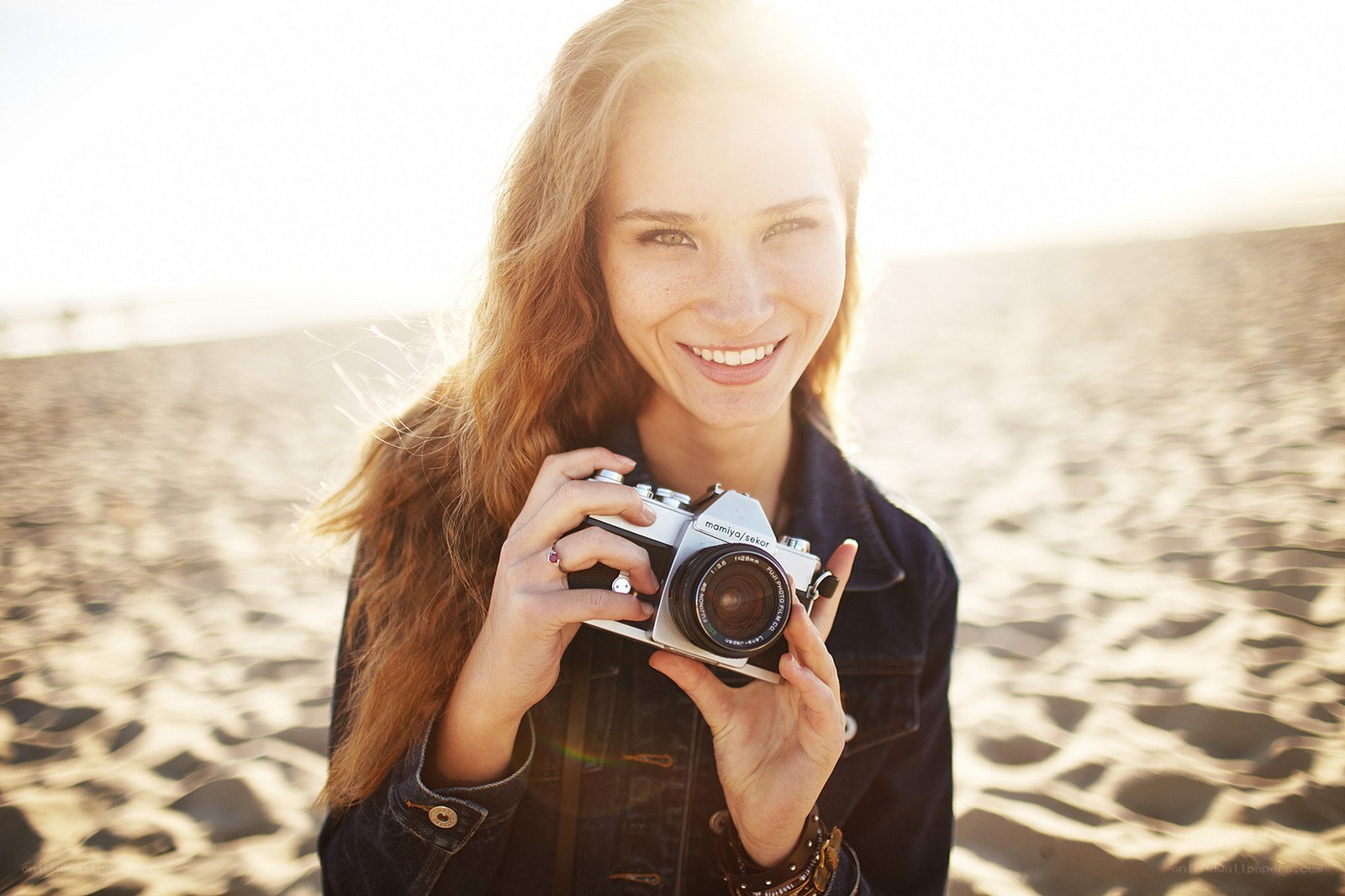 Woman with camera on beach