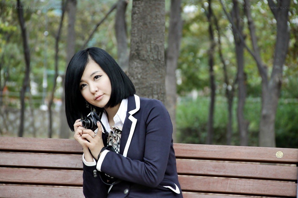 woman with camera on bench