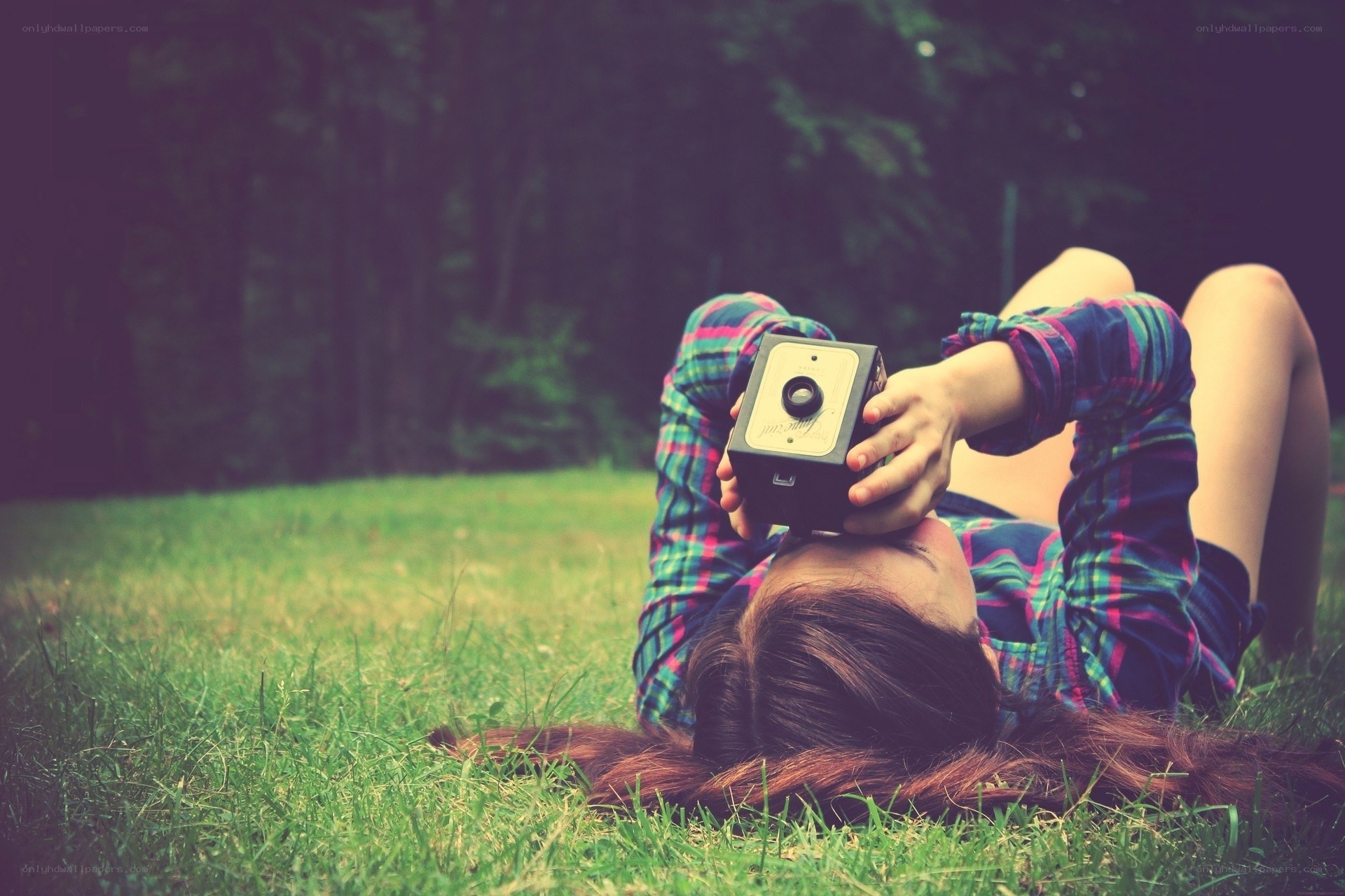 woman with camera on grass