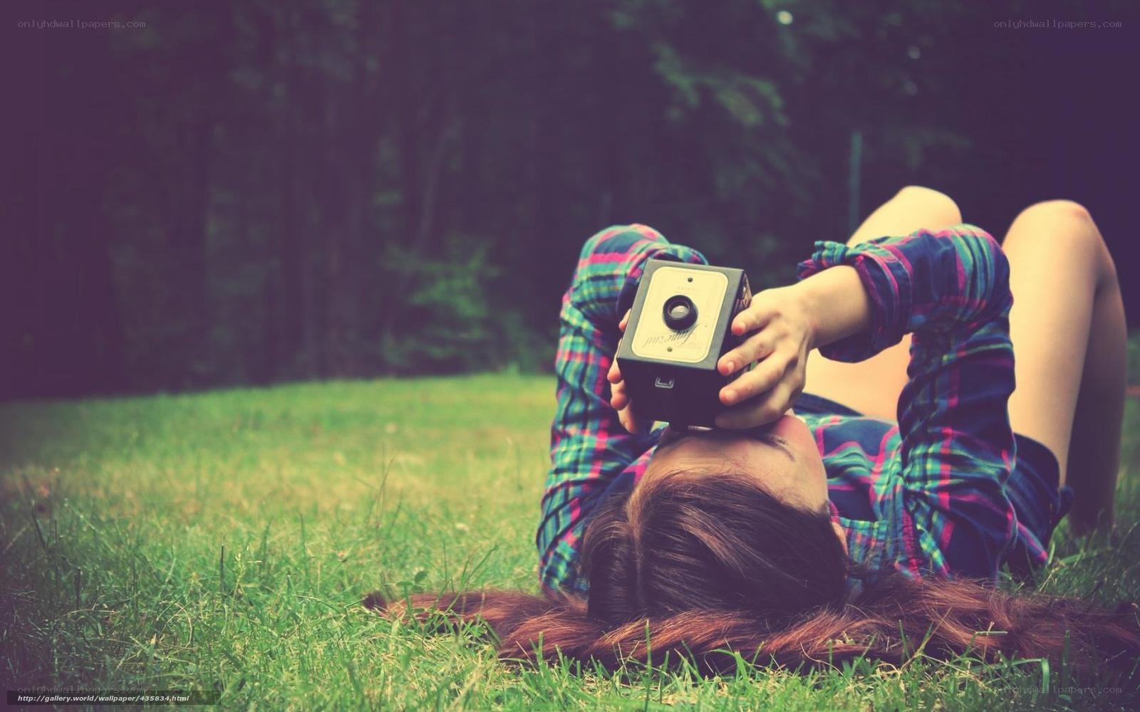 woman with camera on grass