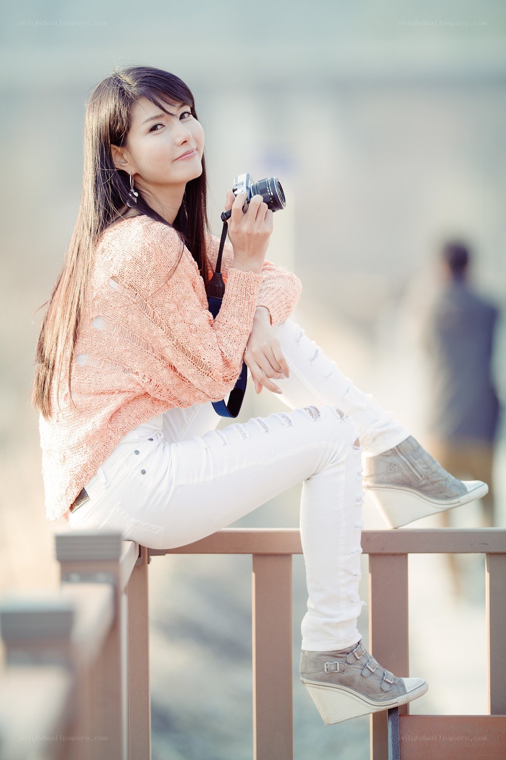 woman with camera on railing