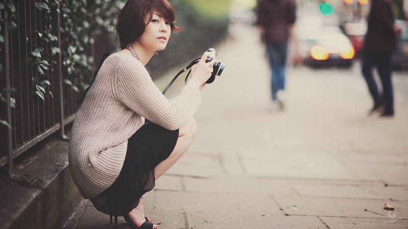 Woman with camera on street