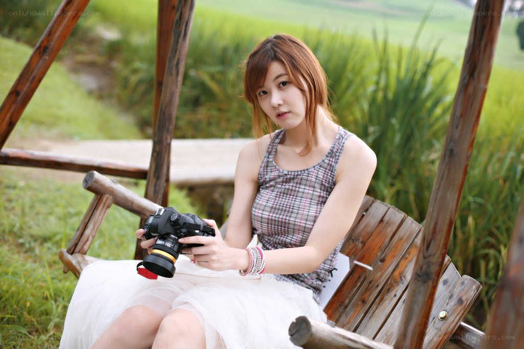 Woman with camera on swing