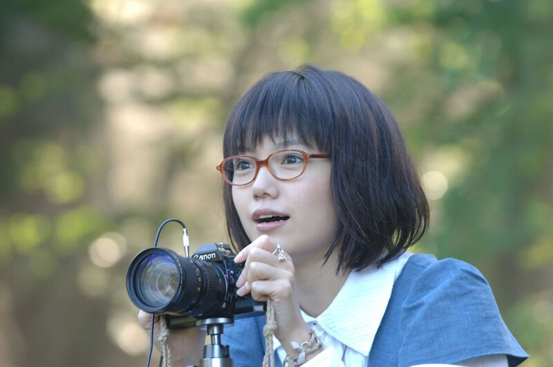 Woman with camera outdoors