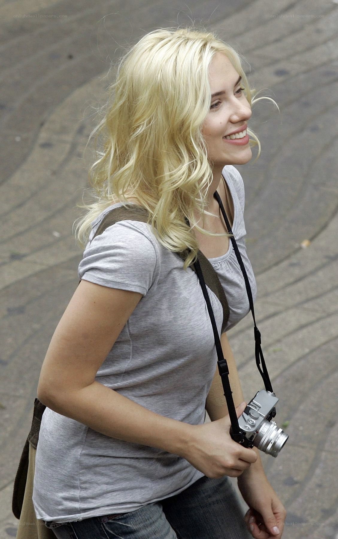 woman with camera smiling