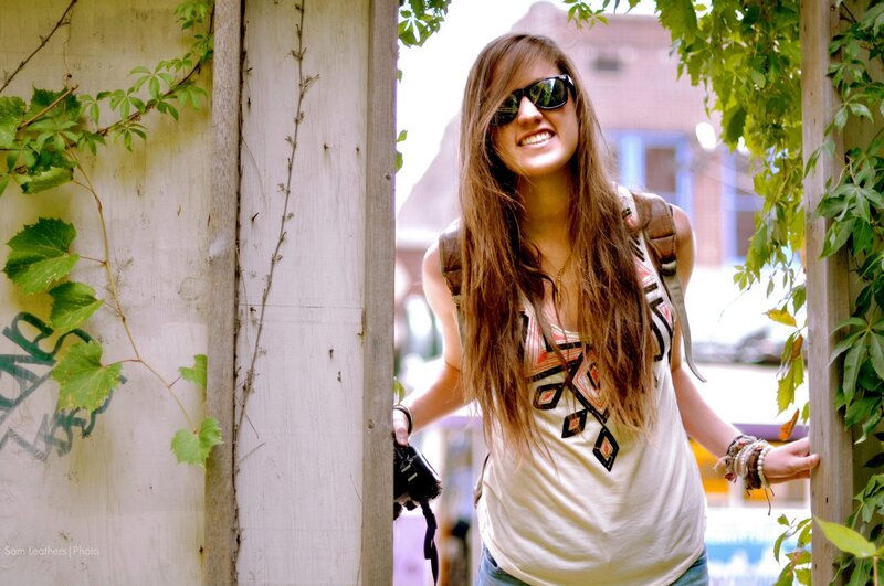 woman with camera smiling