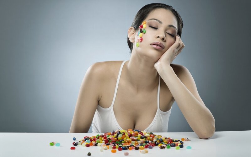 woman with candies on face